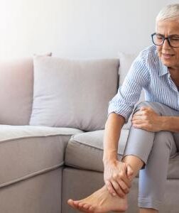 woman sitting on couch leg pain