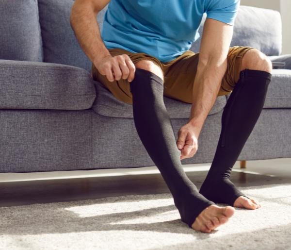 man wearing knee high compression stockings