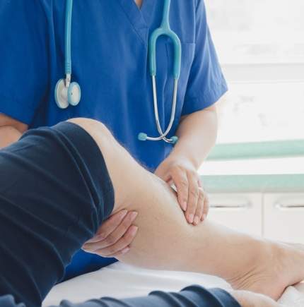 doctor holding leg during examination