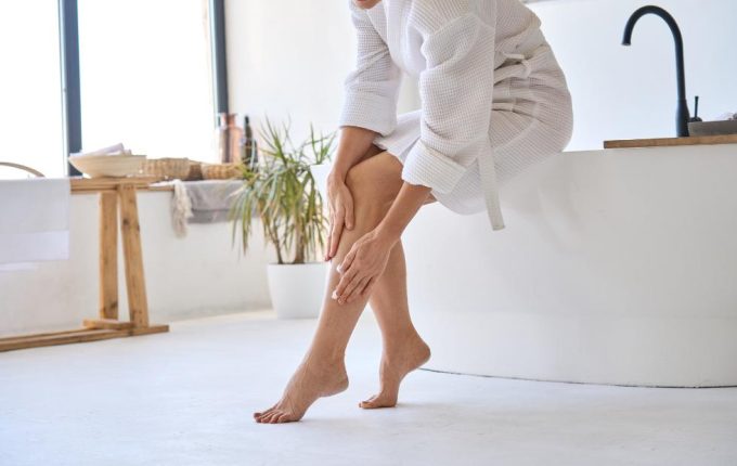 woman rubbing tired legs